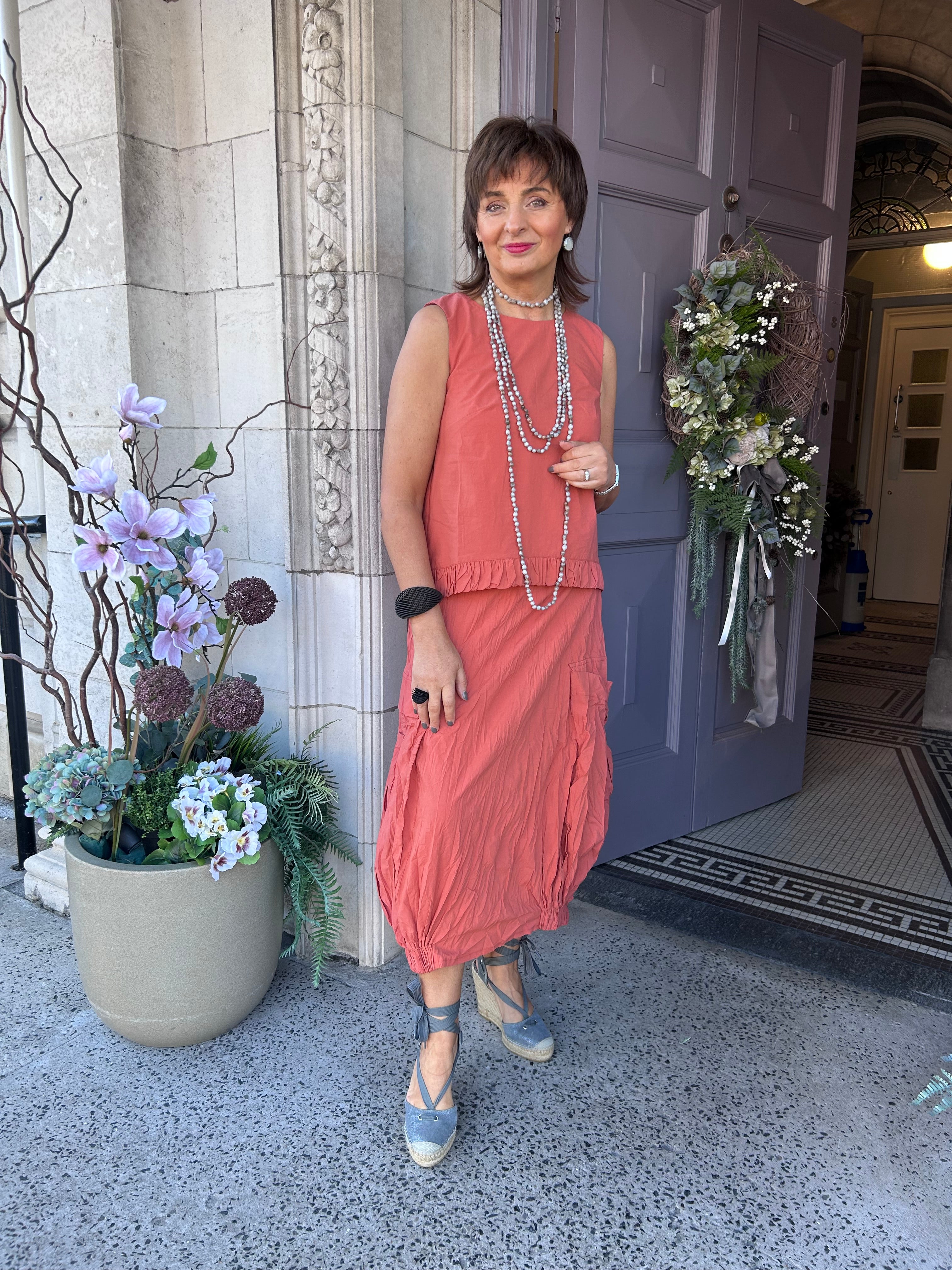 Ruffle Hem Sleeveless Top in Chili